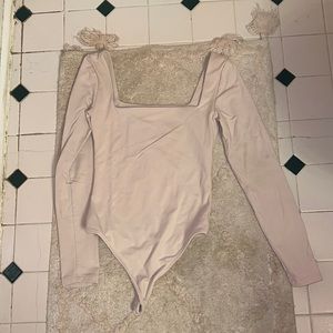 Babaton light pink bodysuit from Aritzia